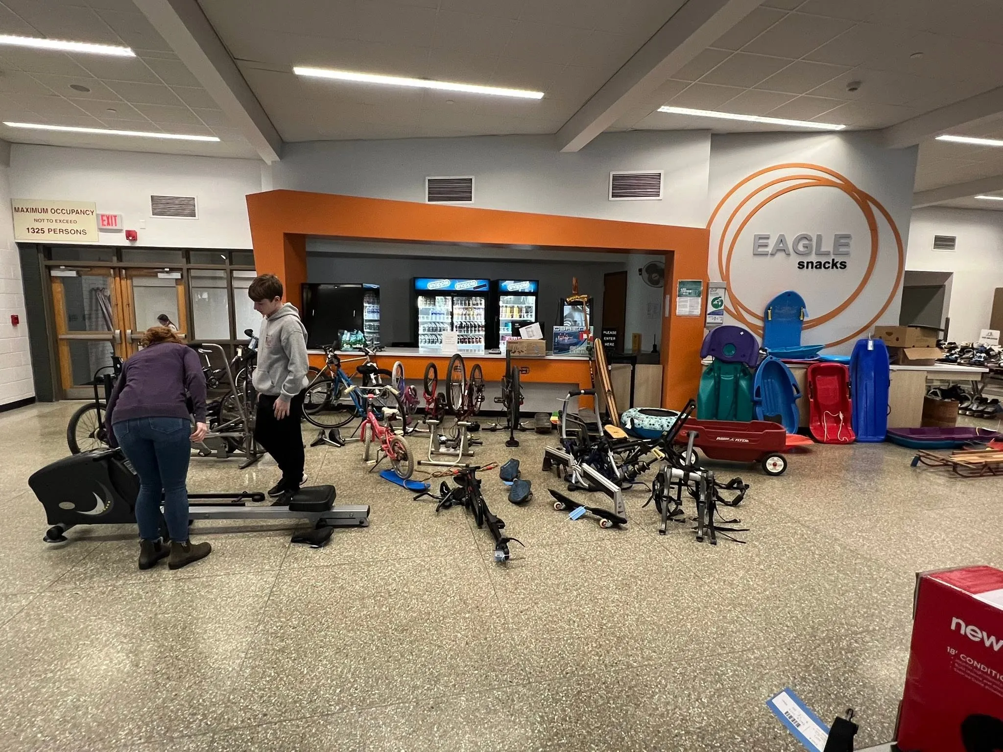 Bikes, an elliptical trainer and sleds laid out for sale