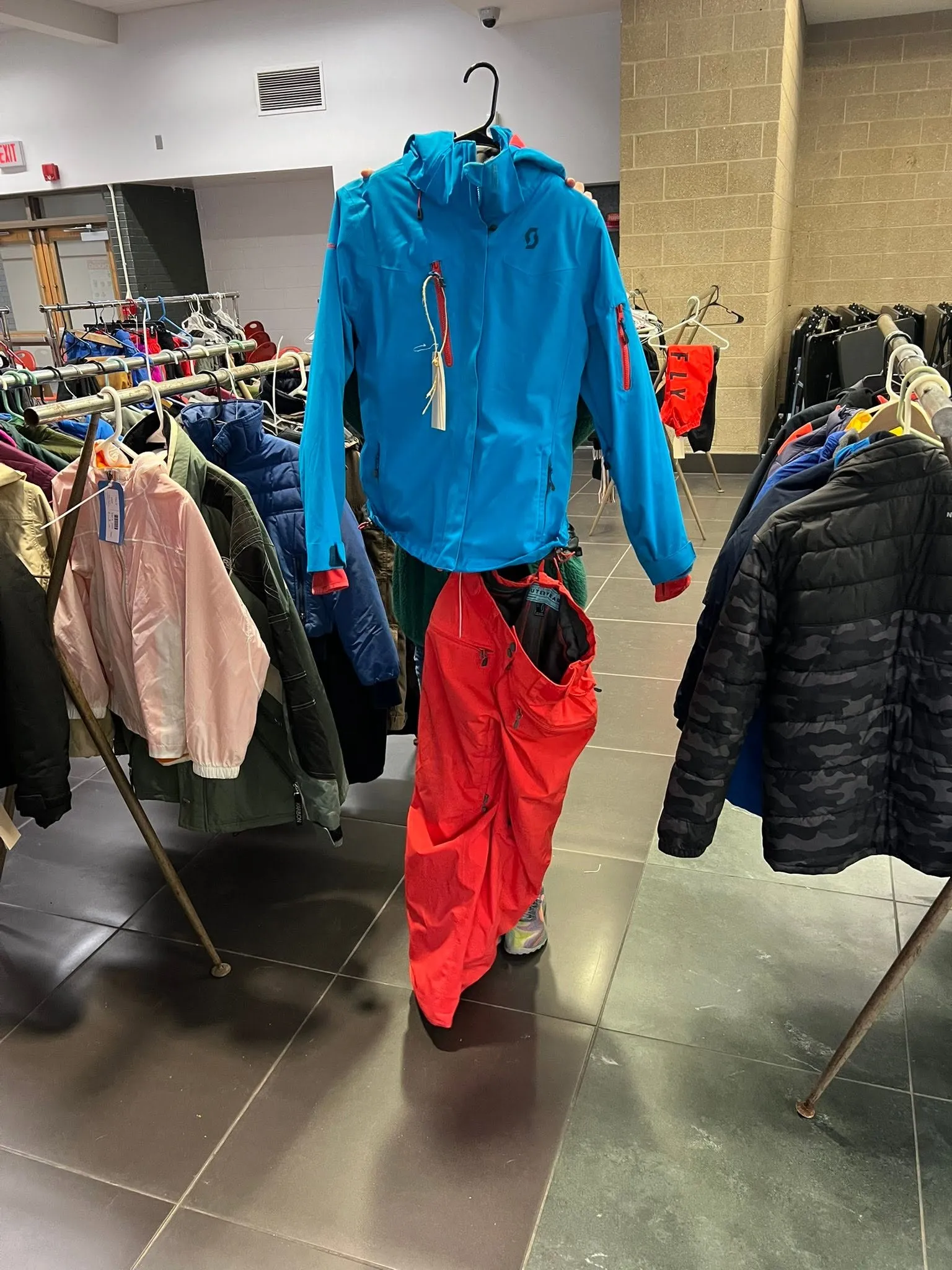 A rack of ski jackets and snow pants
